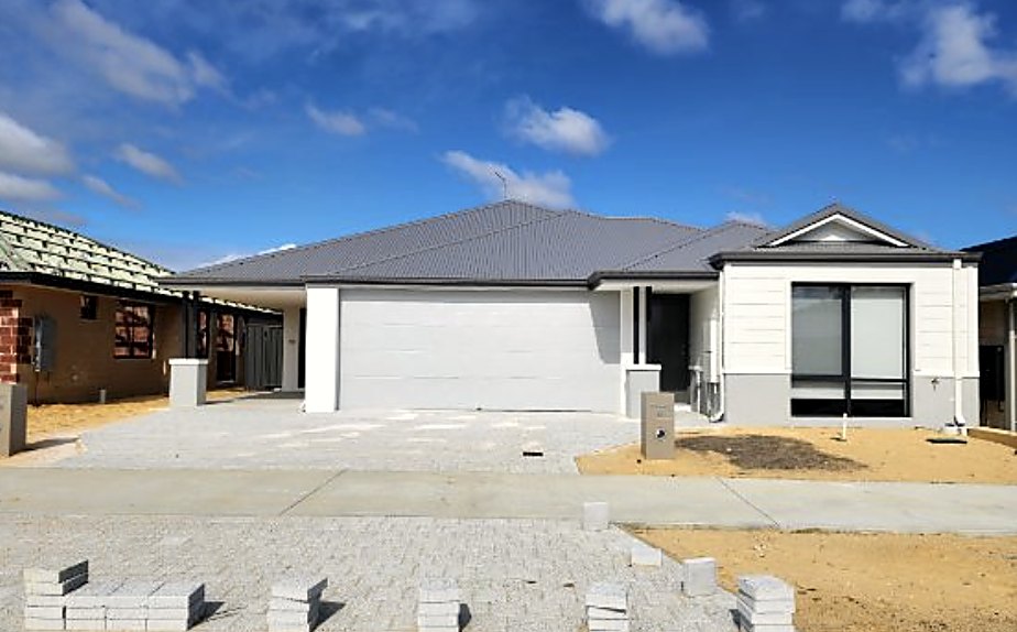 Two self-contained homes under one continuous roofline, photographed shortly after handover